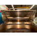 Stainless steel outdoor grill with a large hood in an industrial setting